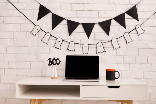 istock Halloween concept in office with open laptop with blank screen 1178125242