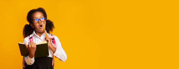 istock Shocked Elementary Student Girl Holding Schoolbook And Pencil, Studio Shot 1178125976