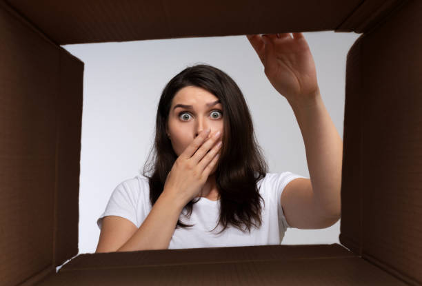 istock Shocked Lady Looking Inside Cardboard Moving Box 1178126196