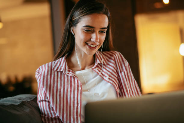 istock Young woman using laptop at home 1178127302