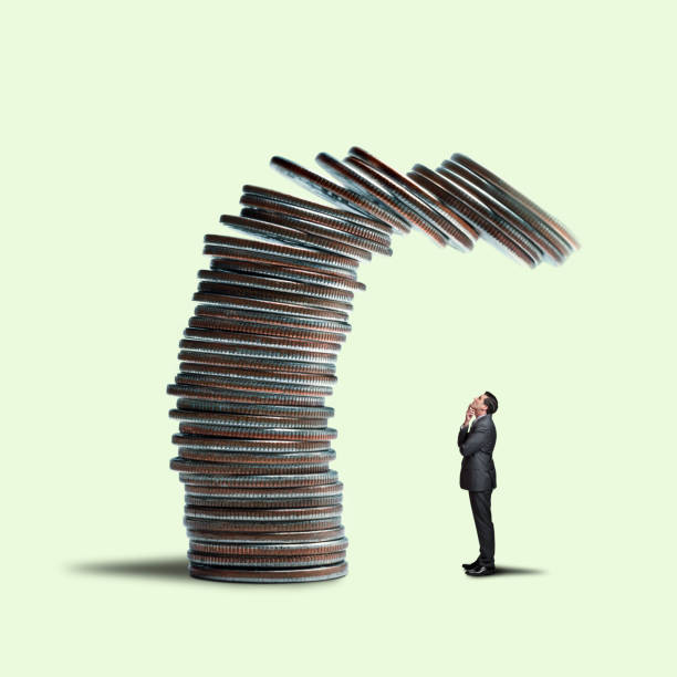 istock Businessman Looking Up At Stack of Coins About To Fall On Him 1178128010