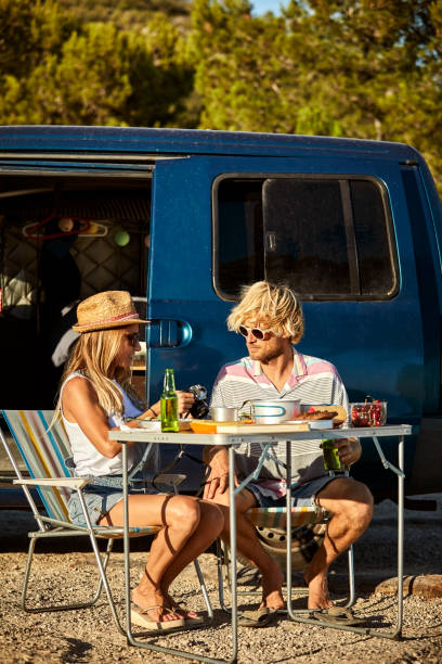 istock Couple with digital camera against mini van 1178129797