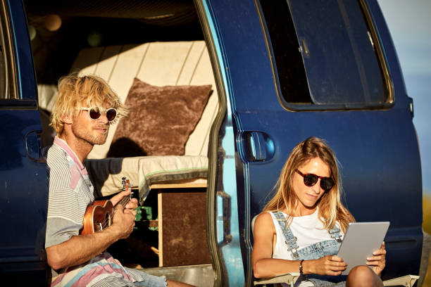 istock Couple with guitar and digital tablet by mini van 1178129813
