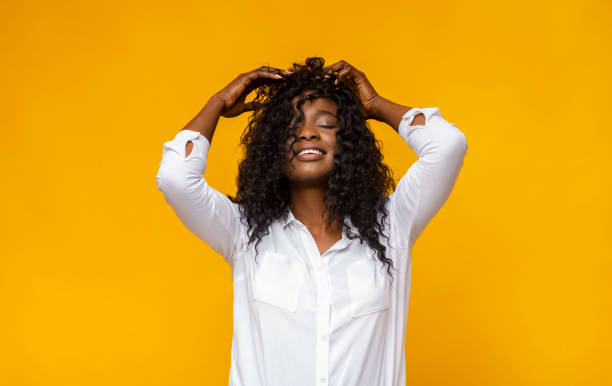 istock Joyful african girl touching her head with closed eyes 1178129850