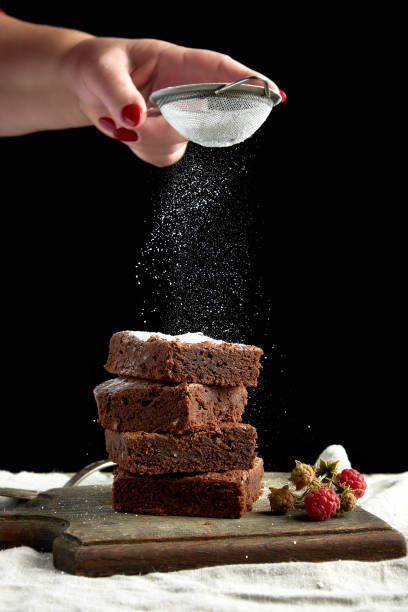 istock stack of square baked brownie chocolate cake slices sprinkled with white sugar 1178131092