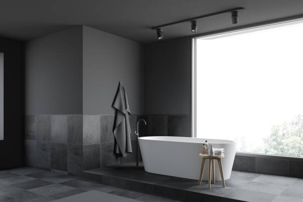 istock Gray and tiled panoramic bathroom corner with tub 1178131254