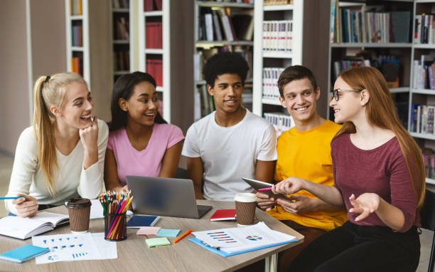 istock Group of multi ethnic teenagers doing homework at library 1178132970