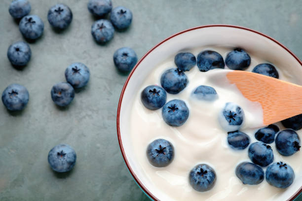 istock Bowl with yogurt and blueberries on table, top view 1178136540