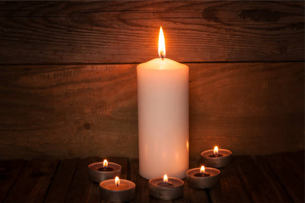 istock Burning candles on wooden background 1178137318