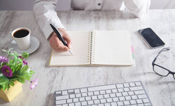 istock Girl writing on notepad in office desk. 1178146159
