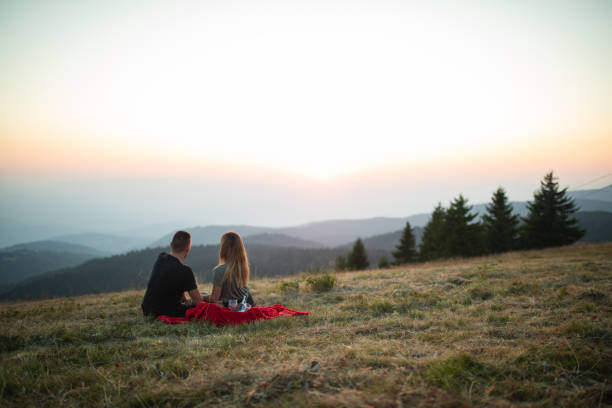 Married couple celebrating anniversary in front of a beautiful mountain view