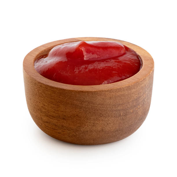 istock Tomato ketchup in small wooden dish isolated on white. 1178152086
