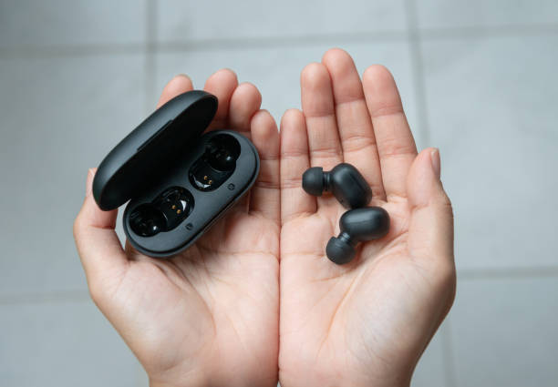 close up of woman is holding the black true wireless earbuds case in hand - open concept audio imagens e fotografias de stock