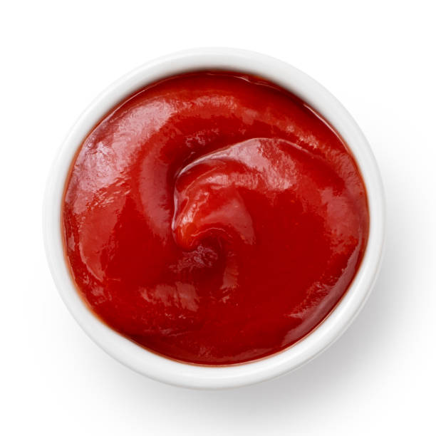 istock Tomato ketchup in small white ceramic dish isolated on white. Top view. 1178152224