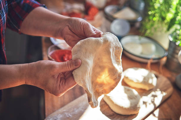 istock Preparing Dough for Pizza in Domestic Kitchen 1178152507