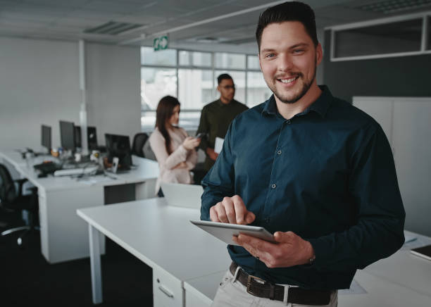 istock Portrait of a confident corporate executive using a digital tablet in a modern office looking at camera 1178152886