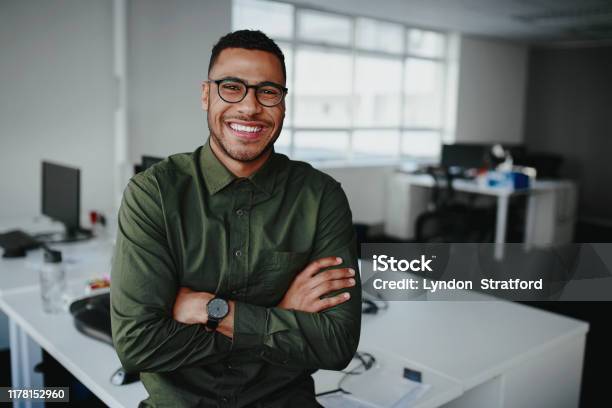 Portrait Of A Happy Confident Young African American Businessman Standing With His Arms Crossed Looking At Camera Stock Photo - Download Image Now
