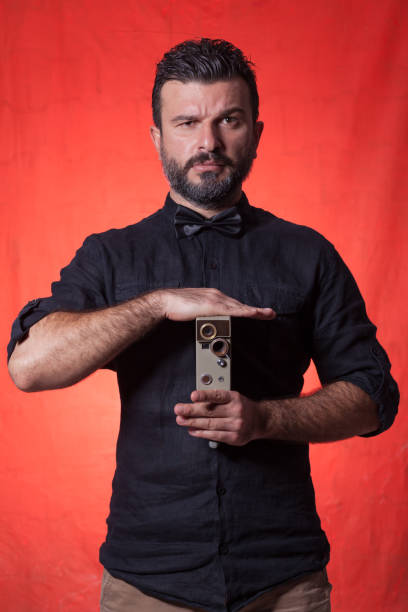 istock The photographer wit retro camera over colored background 1178154261