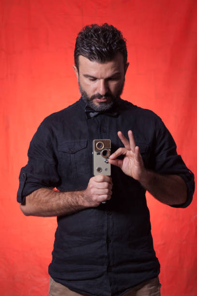 istock The photographer wit retro camera over colored background 1178156251