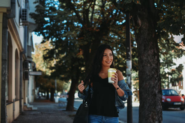 istock Woman drinking coffee in the city 1178160929