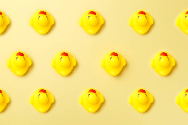 istock Trendy sunlight Summer pattern made with rubber duck on bright light yellow background. Minimal style with colorful paper backdrop. Colorful photo. Flat lay. Copy space. Minimal creative concept 1178160992