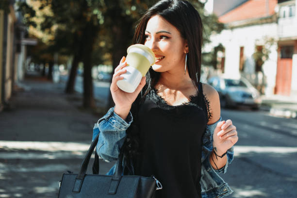 istock Woman drinking coffee in the city 1178161317