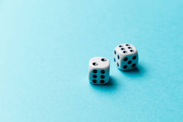 istock White gaming dice on blue background. Top view. Flat lay. Copy space. Game of chance concept. Close-up. Pastel colors 1178162359