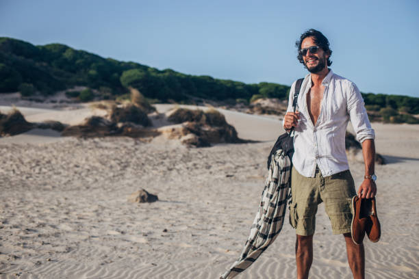 istock Fashionable guy on the beach 1178167416