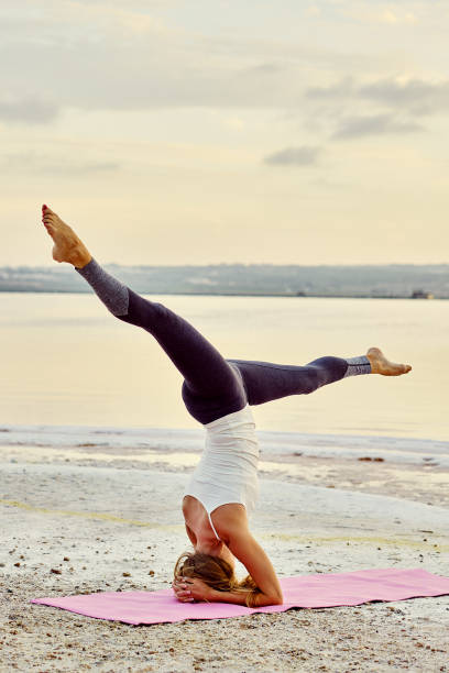istock Yogi woman practising yoga outdoors doing Salamba Sirsasana 1178171085