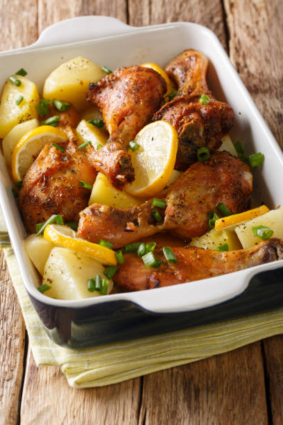 istock Greek chicken with lemon and boiled potatoes close-up in a baking dish. vertical 1178171635