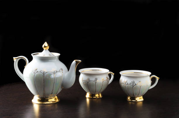 istock Elegant white tea pot and cups on dark background 1178174959