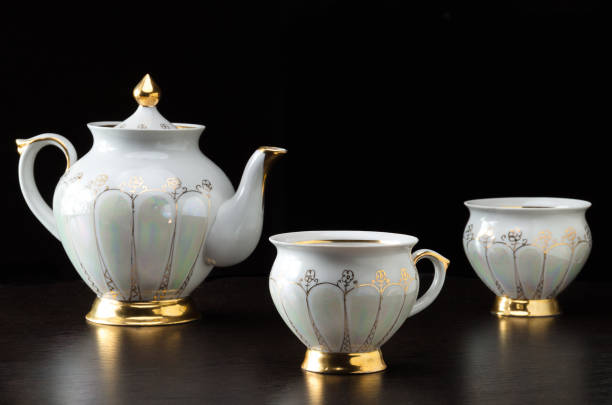 istock Elegant white tea cup an tea pot on dark background - selective focus 1178174961