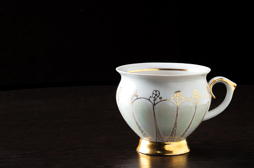 Elegant white tea cup on dark background