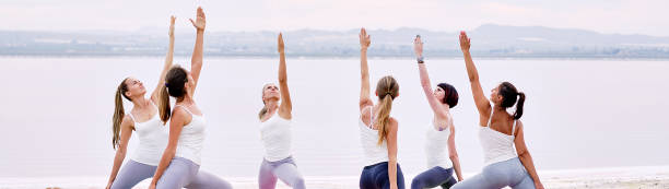 istock Women practicing yoga standing in Warrior pose 1178175138
