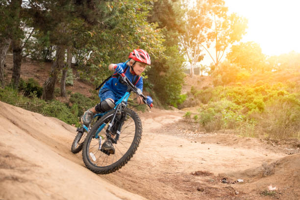 Speedy 7 Year Old Riding A Mountain Bike Speedy 7 Year Old Riding A Mountain Bike speeding through a forest.  Motion blur captures the essence of speed. mountain biking photos stock pictures, royalty-free photos & images