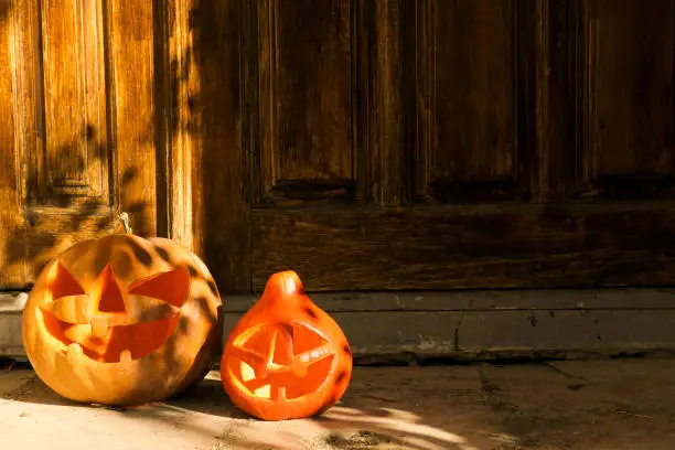 Photo of Jack-O-Lantern pumpking outdoors for all hallows eve. Halloween background.