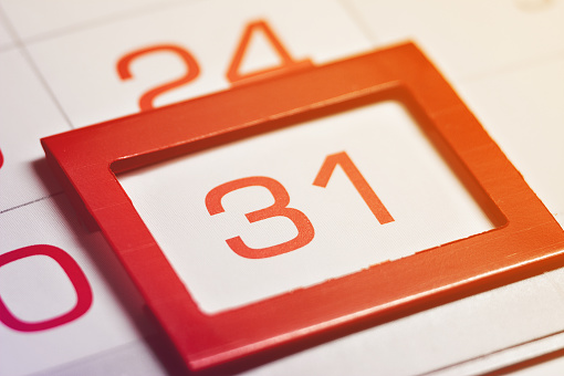 the thirty-first day of the month highlighted on the calendar with a red frame close-up macro, the mark on the calendar, the thirty-first date, toned, light, bright