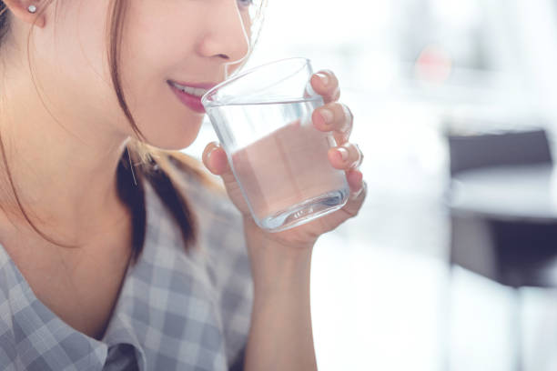 istock Happy woman drinking water while smiling. 1178181348