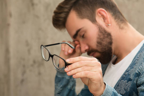 man with tired eyes after long work - human eye tired rubbing businessman imagens e fotografias de stock