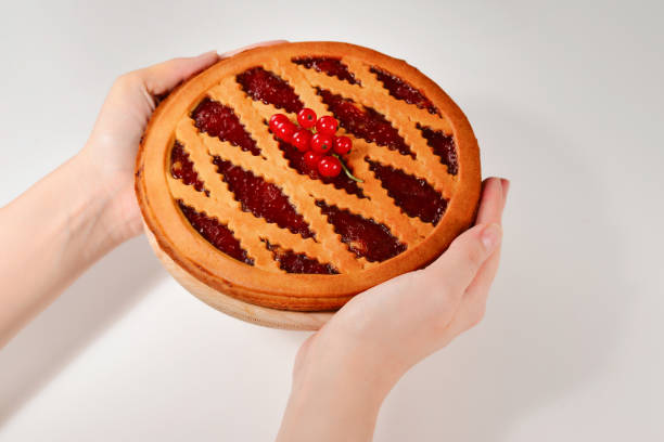 istock Strawberry pie in woman hands isolated on white background 1178181978