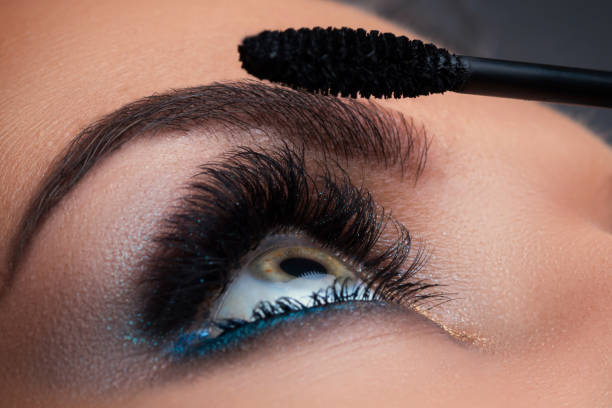 Close up of female eye with beautiful long lashes Close up of female eye with beautiful long lashes and mascara brush mascara wands stock pictures, royalty-free photos & images