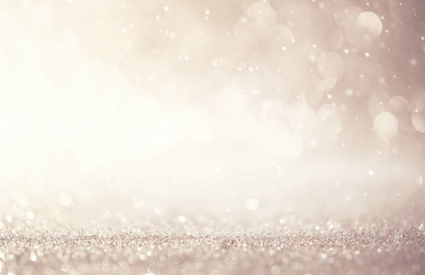 Glitter vintage lights abstract background new year holiday. Silver and white, copy space.