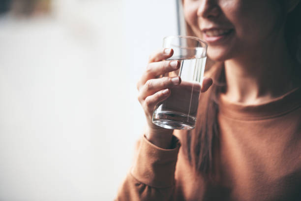 istock Happy woman drinking water while smiling. 1178183577