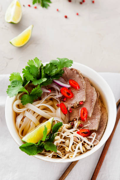 istock Vietnamese Pho Noodle Soup on light table. Beef with Chilli, Basil, Rice Noodles, Bean Shoots showing noodles 1178187466