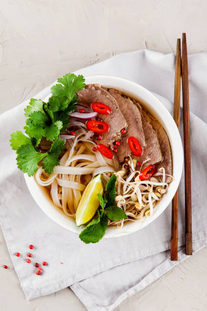 istock Vietnamese Pho Noodle Soup on light table. Beef with Chilli, Basil, Rice Noodles, Bean Shoots showing noodles 1178187581