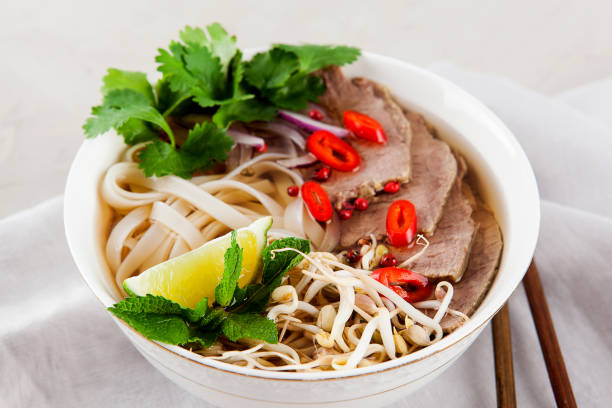 istock Vietnamese Pho Noodle Soup on light table. Beef with Chilli, Basil, Rice Noodles, Bean Shoots showing noodles 1178187695