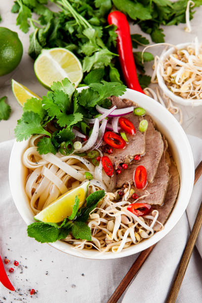 istock Vietnamese Pho Noodle Soup on light table. Beef with Chilli, Basil, Rice Noodles, Bean Shoots showing noodles 1178187700