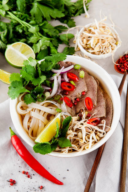 istock Vietnamese Pho Noodle Soup on light table. Beef with Chilli, Basil, Rice Noodles, Bean Shoots showing noodles 1178187775