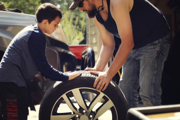 istock Father and son changing a tire 1178188120