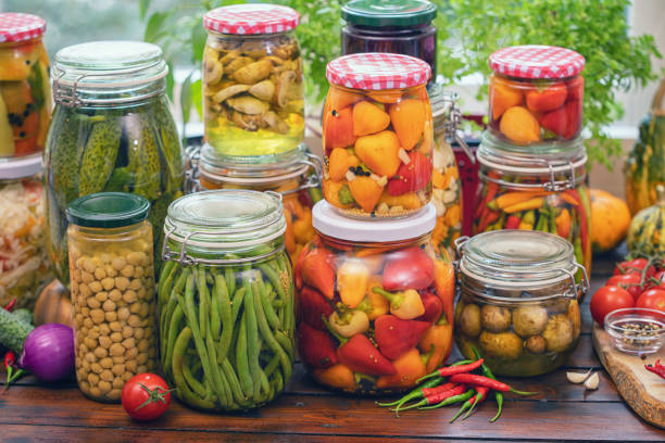 Freshly pickled organic vegetables in jars at home